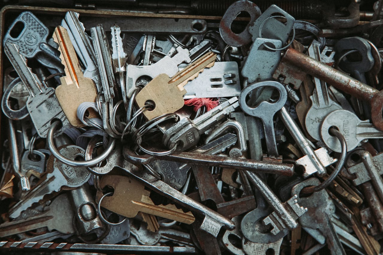 Assorted rusty metal keys piled together, showcasing a vintage and industrial feel.